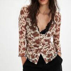Free People Cowgirl Tango Top in a brown and white cow print with long sleeves